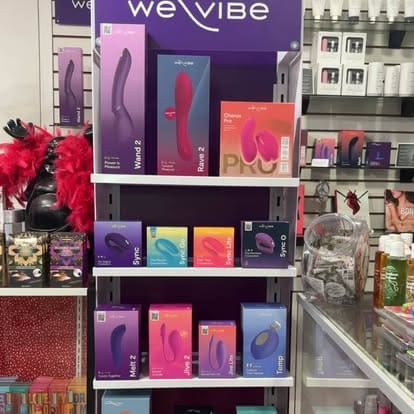 Retail display shelf filled with colorful We-Vibe adult wellness product boxes at Paradise for Adults in Centralia, WA.