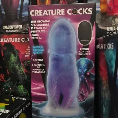 A retail display box for a Creature Cocks brand glowing sea creature adult toy with a remote control, sitting in a pyramid in Paradise for Adults in Centralia, WA.