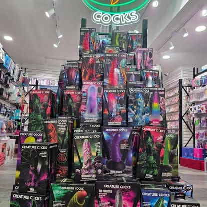 A pyramid-shaped retail store display of boxed Creature Cocks fantasy adult novelties inside Paradise for Adults in Centralia, WA.